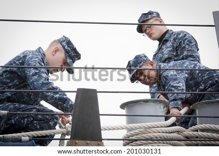 STATEN ISLAND, NY - MAY 21: Sailors aboard the guided-missile destroyer USS McFaul (DDG 074) tend the lines as the ship docks at Sullivans Piers during Fleet Week NY on May 21, 2014.
