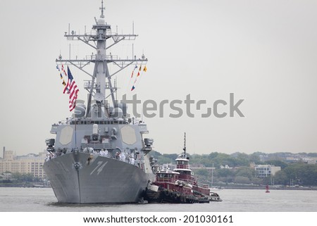 STATEN ISLAND, NY - MAY 21, 2014: The guided-missile destroyer USS McFaul (DDG 074) is guided into port at Sullivans Piers on May 21, 2014. The ship is part of Fleet Week NY.