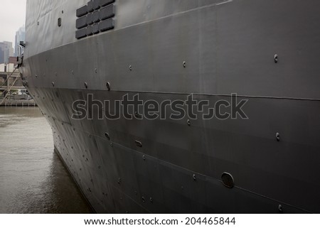 NEW YORK - MAY 22: The gray port side of the hull of the amphibious dock landing ship USS Oak Hill (LSD 51) moored at Pier 92 during Fleet Week NY on May 22, 2014.