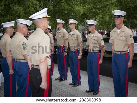NEW YORK - MAY 23, 2014: U.S. Marines stand at attention during the re-enlistment and promotion ceremony at the National September 11 Memorial site.