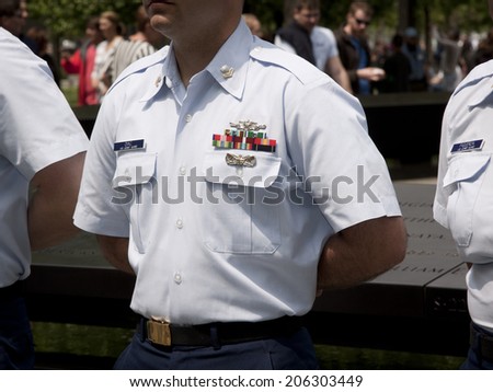 NEW YORK - MAY 23, 2014: A close up of a United States Coast Guardsman standing at attention during the re-enlistment and promotion ceremony at the National September 11 Memorial site.