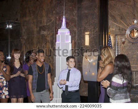 NEW YORK - OCT 16, 2014: Laverne Cox, actress in \'Orange Is The New Black\' and cast members from her documentary \'The T Word\' at the ceremony to light the Empire State Building purple.