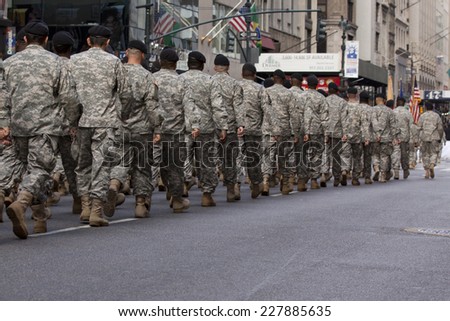 NEW YORK - NOV 11, 2013: Members of the US Army wearing ACU\'s march during the 2013 America\'s Parade held on Veterans Day in New York City on November 11, 2013.