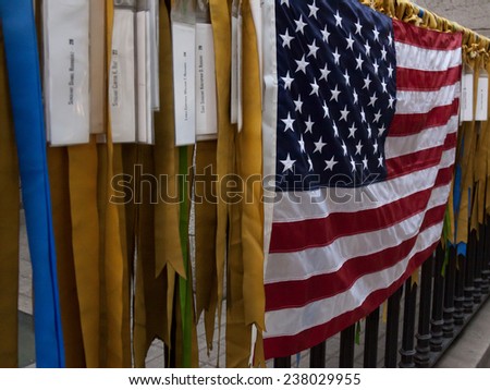 NEW YORK - NOV 11, 2014: Ribbons and the American Flag on an iron fence symbolize prayers for lives lost in the Iraq and Afghanistan wars at Marble Collegiate Church in Manhattan on Veterans Day 2014.