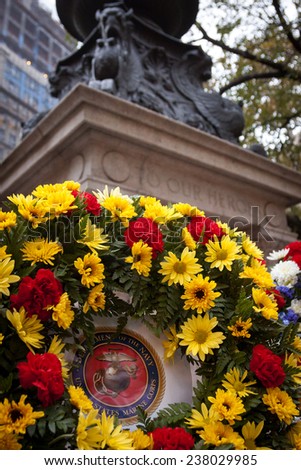 NEW YORK - NOV 11, 2014: A US Marine Corps floral wreath of gold and scarlet placed by the Eternal Light Flagstaff monument in Madison Square Park on Veterans Day in Manhattan on Nov 11, 2014.