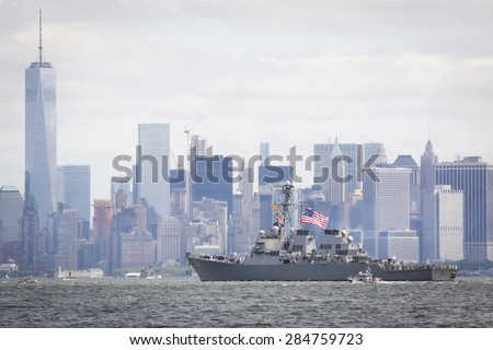 STATEN ISLAND, NY - MAY 20 2015: USS Barry (DDG 52) passes the Freedom Tower of One World Trade Center in Lower Manhattan along the Hudson River during the Parade of Ships, which begins Fleet Week.