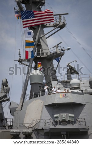 STATEN ISLAND, NY - MAY 20 2015: The conning officer, commander, and harbor master aboard the guided-missile destroyer USS Stout (DDG-55) guide the ship into port at Sullivans Pier for Fleet Week NY.