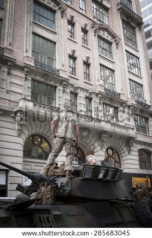 NEW YORK - MAY 21 2015: US Marines on top of a military tank parked on the street during a demonstration for the public at Bryant Park for Marine Day during Fleet Week NY.