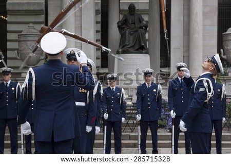 NEW YORK - MAY 21 2015: The US Coast Guard Ceremonial Honor Guard Silent Drill Team perform an air-toss movement of rifles with fixed bayonets in Bryant Park during Fleet Week NY.