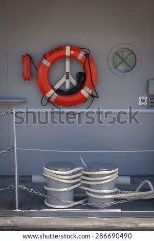 NEW YORK - MAY 22 2015: Lines around mooring bollards and life ring on a US Naval Academy Yard Patrol Craft used for at-sea training and research by students, moored at Pier 86 for Fleet Week NY 2015.