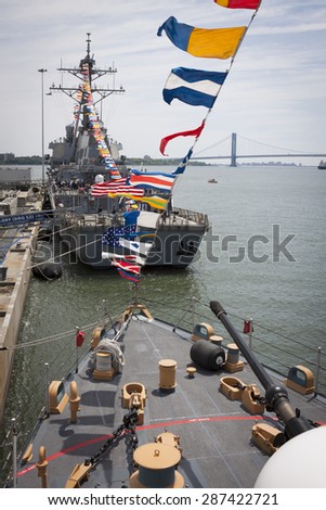 STATEN ISLAND, NY - MAY 24 2015: USS Barry (DDG 52) moored at Sullivans Pier as seen from the bridge of USCGC Spencer (WMEC 905) with the Verrazano Narrows Bridge in the background at Fleet Week 2015.