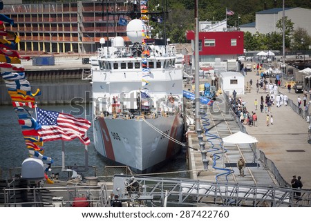 STATEN ISLAND, NY - MAY 24 2015: An overview of people walking by the USCGC Spencer (WMEC 905) a Medium endurance cutter and the Sullivans Pier during Fleet Week NY 2015.