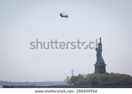 JERSEY CITY, NJ - MAY 26 2015: US Marine Corps helicopters fly past the Statue of Liberty on the Upper New York Bay before the USS San Antonio departs Pier 92 at the end of Fleet Week NY 2015.