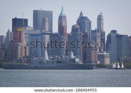 JERSEY CITY, NJ - MAY 26 2015: USS San Antonio (LPD 17) passes Lower Manhattan on the Upper New York Bay after departing Pier 92 at the end of Fleet Week NY 2015.