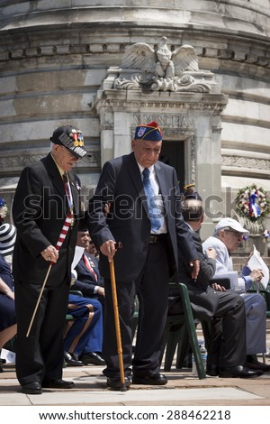 NEW YORK - MAY 25 2015: Two US veteran make their way to the stone steps of the Soldiers and Sailors Monument after the Memorial Day Observance service held in Manhattan during Fleet Week NY 2015.