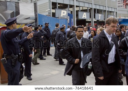 NEW YORK - MAY 2: Commuters walk past Port Authority Police Officers as they exit the World Trade Center PATH train station on May 2, 2011 in New York City. Osama bin Laden was killed in Pakistan by US Seals the day before.