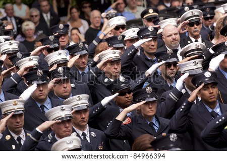 NEW YORK - SEPT 11: Firefighters salute during a ceremony at the Firefighters Memorial on September 11, 2011 in New York. Firefighters from around the world attended the ceremony.