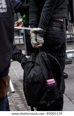 NEW YORK - NOV 17:  Police check the knapsack belonging to an unidentified woman arrested at Broad and Beaver Streets during the Occupy Wall Street protests on November 17, 2011 in New York City, NY.