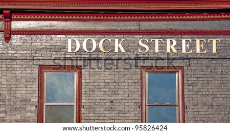 Letters on the side of a building that spell Dock Street.