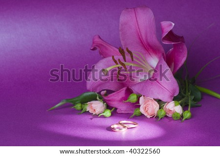 stock photo wedding bouquet and rings on magenta background