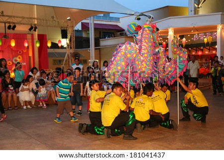 PENANG, MALAYSIA- FEB 2, 2014 : Dragon dance performance attracted crowd of family and children at a public premises during Chinese New Year 2014.