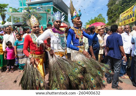 KUALA LUMPUR, MALAYSIA - FEB 3,2015: Three hindu pilgrims wearing peacock costume at the batu cave temple, Kuala Lumpur Malaysia during Thaipusam festival on 3rd FEB 2015.