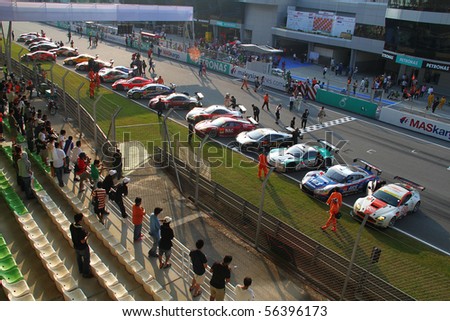 SEPANG, MALAYSIA-JUNE 20 : Race cars stop along the finishing line after the end of the Super GT car race on June 20, 2010 in Sepang Circuit, Malaysia.