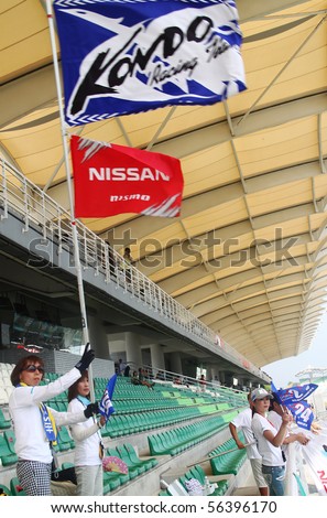 SEPANG, MALAYSIA-JUNE 20 : NISSAN supporter association members giving moral supports to their japanese comrades at Super GT car race on June 20, 2010 in Sepang Circuit, Malaysia.