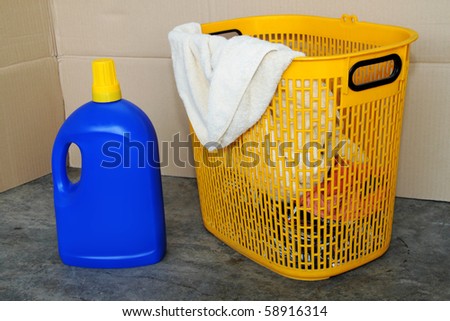 Dirty laundry in the basket for washing with detergent and pail of water. Concept of daily household chore, contain clipping path.