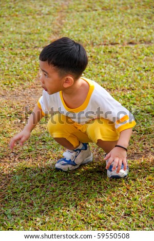 KUALA LUMPUR - AUGUST 15 : Unidentified kid prepare to jump up at Taman Midah Kindergarten sport day on August 15, 2010 in Kuala Lumpur Malaysia.