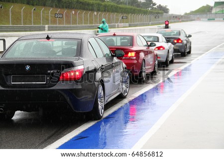SEPANG - CIRCA MAY 2010: Anonymous BMW car owners test drive their cars at Sepang race track, Malaysia, during a rainy HPC track day circa May 2010.