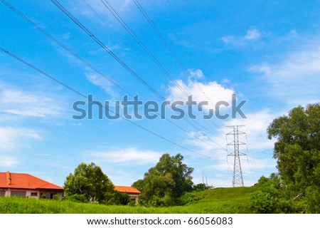 Power cable tower on a hill near housing area. Concept of power transmission.