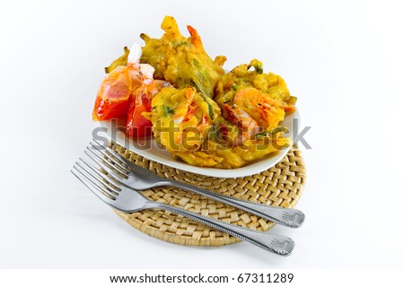 Delicious prawn fritters snack with packs of chilli sauce isolated on white. Concept of asian snack.