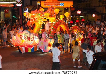 KUALA LUMPUR, MALAYSIA-MAY 17: A dragon design floats with its marching followers on Wesak Day procession at Petaling Street, Malaysia on 17 May,2011.