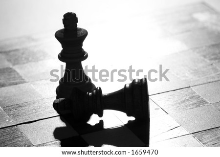 Two pieces of chess, one has won against the other (in black and white)