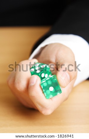 A businessman rolling a dice