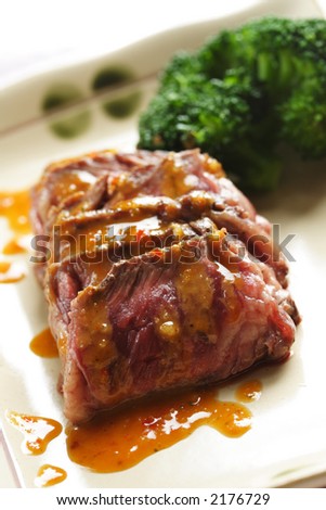 Slices of tender beef served with peanut sauce and vegetables