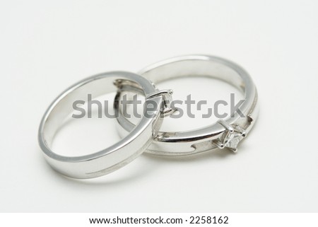 stock photo Two white gold wedding rings on silver background