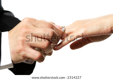 stock photo The groom and bride exchanging rings during wedding ceremony