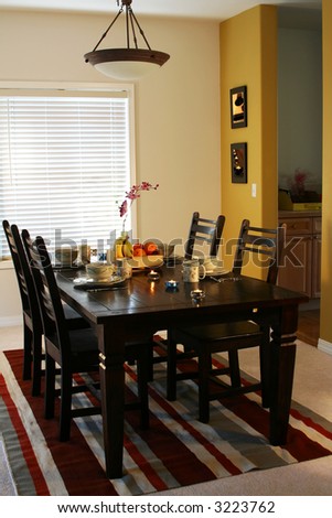 Dining table and plates on a dining table (note: pics on the wall are mine)