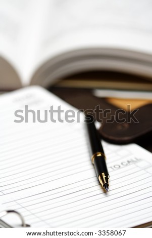 A meeting planner and a pen, showing a business meeting concept