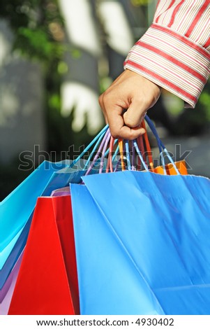 A shot of a young man carrying shopping bags