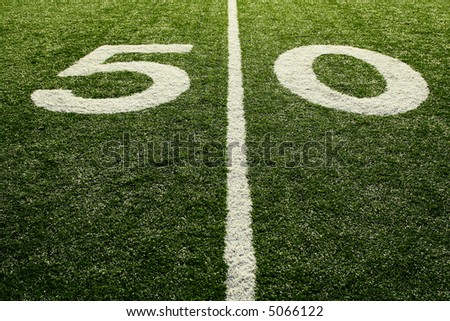 A shot of a 50 yardline at an american football field