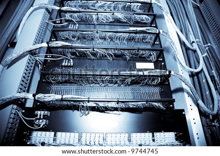 A shot of network equipment in a data center (in blue tone)