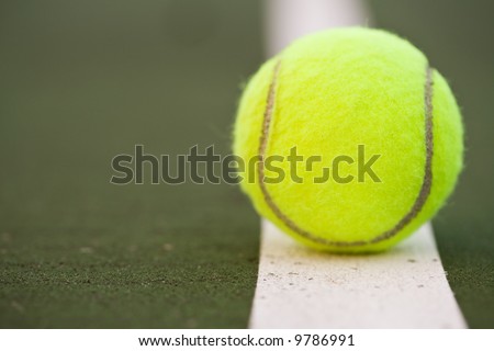 A closeup shot of a tennis ball in a tennis court