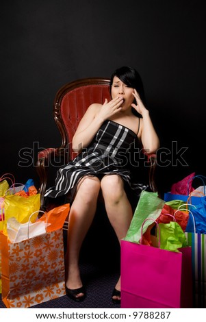 A tired and exhausted woman resting on a chair after shopping