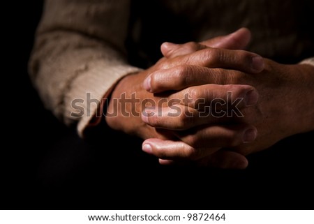 A shot of hands of an old man praying