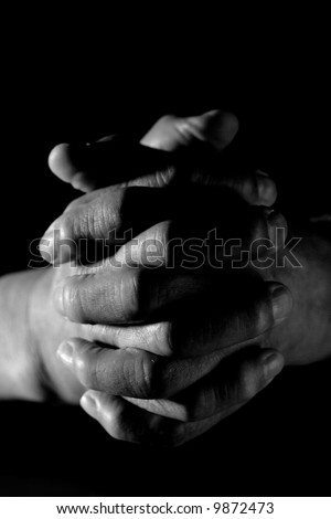 stock photo : A closeup shot of praying old hands in black and white