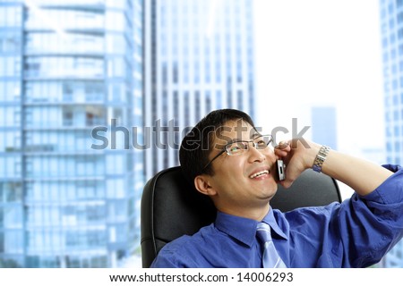 A shot of an asian businessman talking on the phone at the office