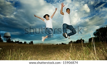 A shot of an asian couple jumping for joy
